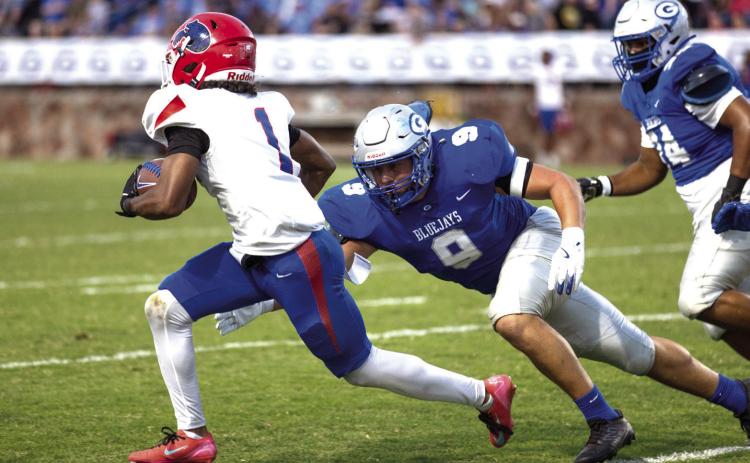 Senior Kellen Hirzel goes in for a tackle against the Bears’ Andre Blake.