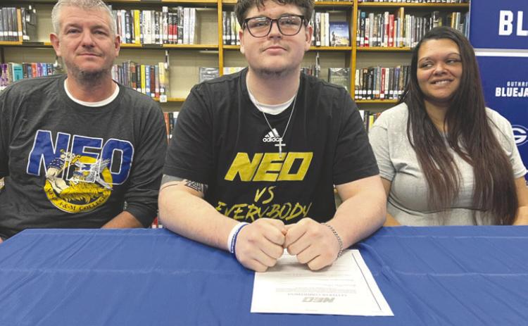 Guthrie High School senior Ethan Gilbert signs his letter of intent to play college football at NEO A&M during a National Signing Day ceremony. Gilbert was a two-year starter on the Bluejays’ offensive line. Photo courtesy of Guthrie News Page.
