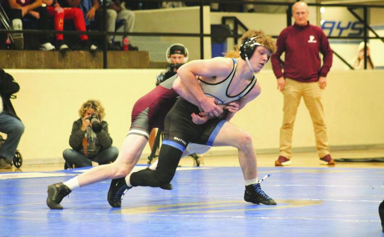 Guthrie's Aydin Smith fights with Perry's Carson Avery in a dual between the two schools, Thursday, Dec. 5.