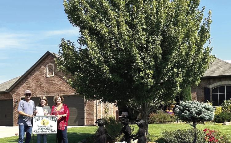 Guthrie Jonquil Garden Club is pleased to announce Yard of the Week honoring Jack & Sandy Clendenny, 12446 Blue Meadow. Pictured L to R: Jack, Sandy & Dana Bertrand, Garden Club member.