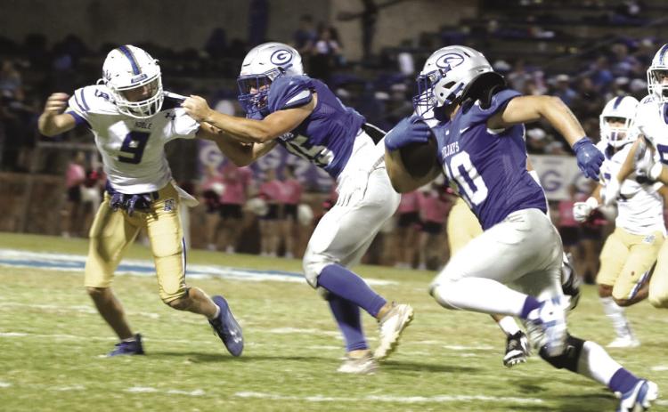 Blake Doles around the end as the tackle holds the defensive end.