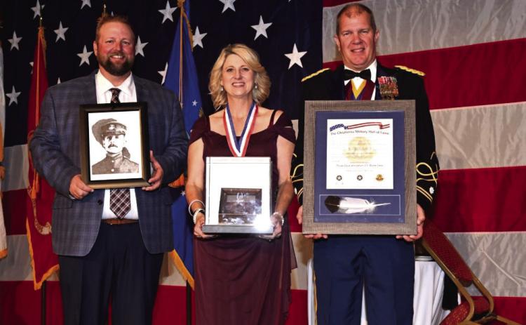 Accepting Oscar Upham’s induction into the Oklahoma Military Hall of Fame are (from left) Cody Hayes, Kathy Hayes and Lt. Col. T. Kyle Brede.