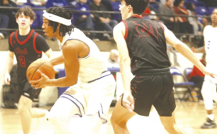 Nate Benford drives to the basket against Elgin.