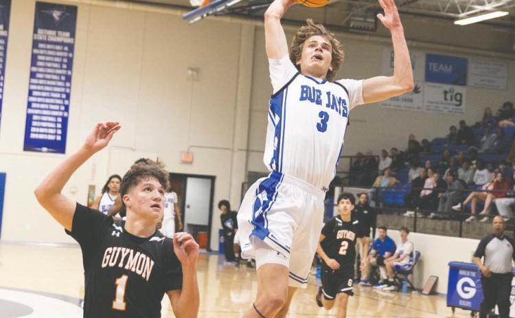Guthrie’s Kolson Smedley goes up for one of his eight slam dunks against Midwest City on Jan. 16. Photo by Brent Fuchs.
