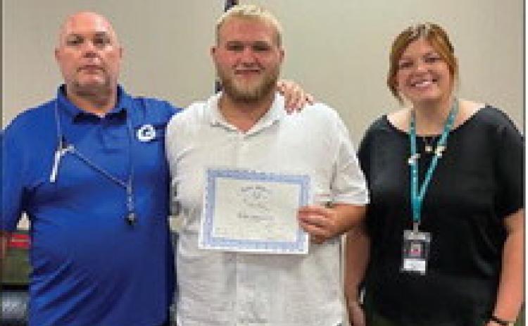 Pictured with Cooper is GHS Football Coach, Kelly Beeby and Rotary President, Coy McPeek.