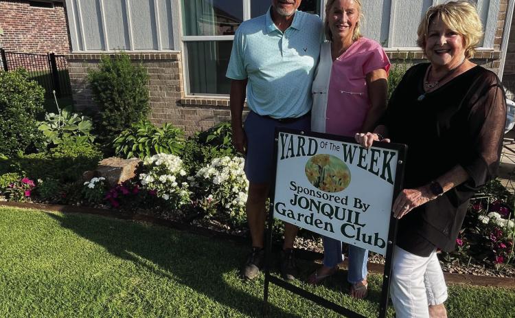 The Jonquil Garden Club is pleased to announce another beautiful yard of the week. Pictured L to R: Mike &amp; Leigh Ann Baldwin, 1601 Porter Street &amp; garden club member Dana Bertrand.