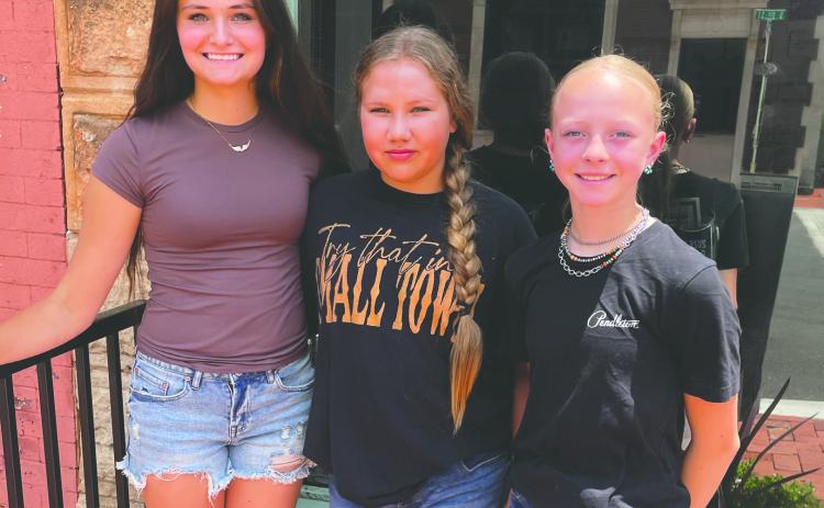 Carlee Weinberger (left), Stevie Kurle (center) and Brendle Mott, all of North Dakota, take a break from competition at the National Junior High Finals Rodeo at the Lazy E Arena in Guthrie, Okla., to explore downtown shopping. The young competitors said meeting new people, building friendships and experiencing the rodeo community have been highlights of their week at the national event. Photo by Guthrie News Leader.
