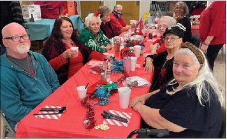 Attendees visit with one another while waiting to be served lunch at Highland Hall in Guthrie during the Logan County Aging Services Christmas dinner, where seniors gathered to enjoy a holiday meal and time with friends. Photo by Nikki Bos